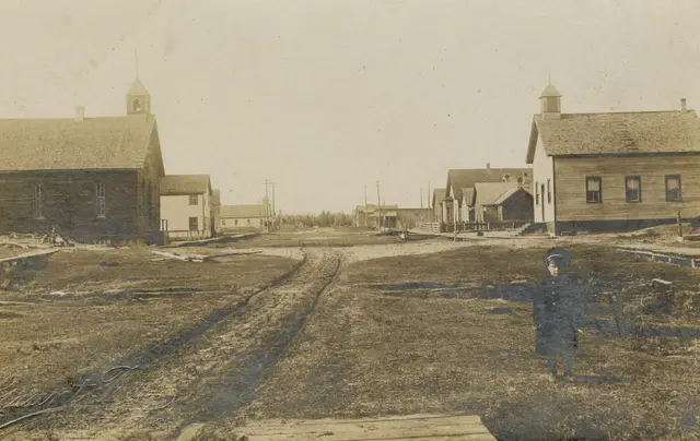 Main street of Vanguard with a boy standing in the road